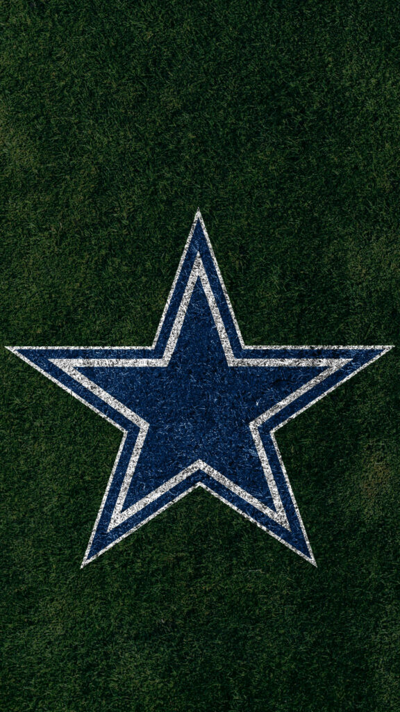 Dallas Cowboys logo blue white star on textured green field football team pride wallpaper