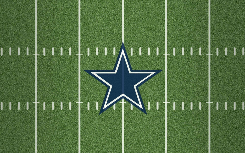 Dallas Cowboys star logo on green football field with white yard lines vibrant sports wallpaper