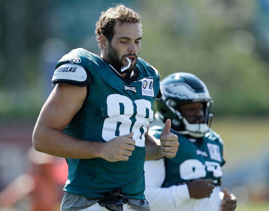Dallas Goedert wearing Eagles green jersey 88 focused during outdoor training session with teammate Wallpaper