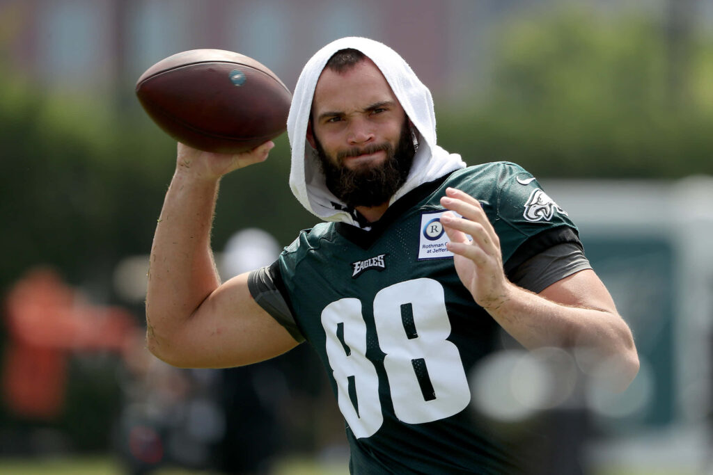 Dallas Goedert Philadelphia Eagles focused throwing football training NFL tight end athletic energy Wallpaper
