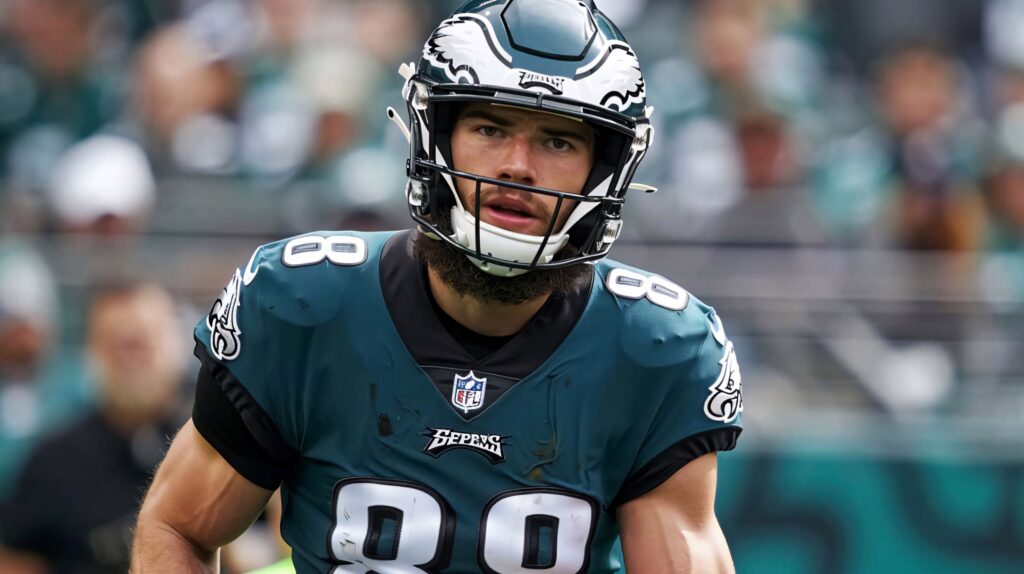 Dallas Goedert #88 in Eagles uniform intense football action vibrant green white wallpaper