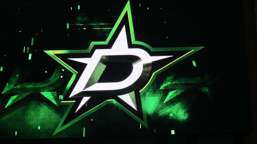 Dallas Stars silver metal logo on dynamic green and black background with glowing accents Wallpaper