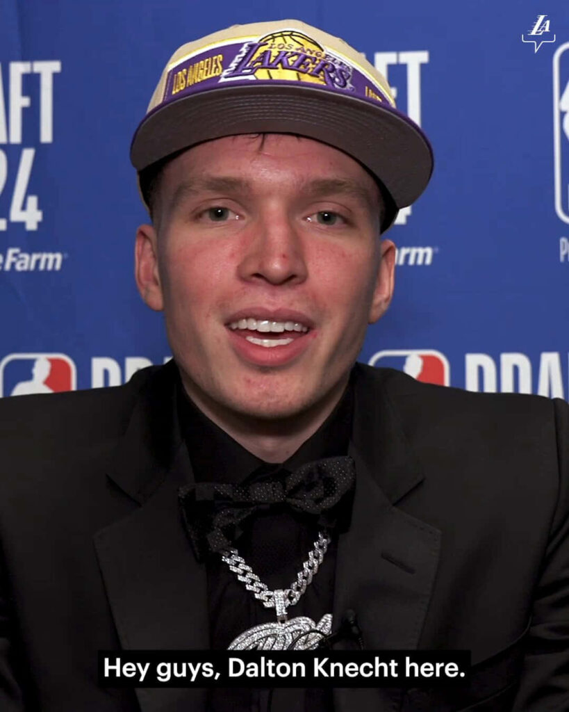 Dalton Knecht in Lakers cap and black suit with bow tie at NBA Draft 2024 blue backdrop event Wallpaper