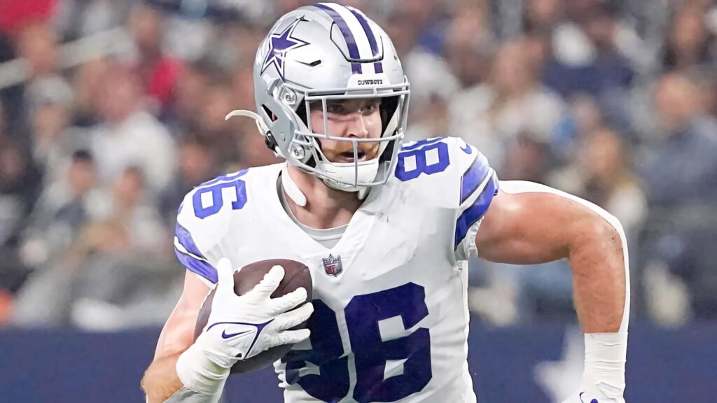 Dalton Schultz Dallas Cowboys football player running with ball in vibrant stadium action wallpaper
