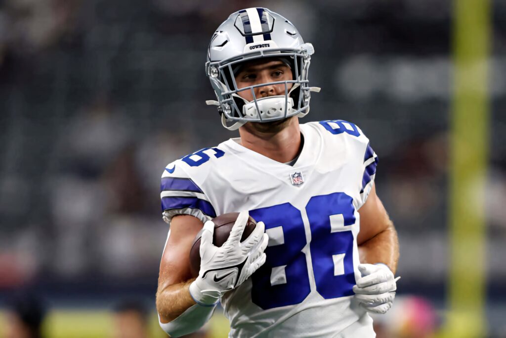 Dalton Schultz Dallas Cowboys mid game in silver blue uniform showcasing focus and athleticism Wallpaper