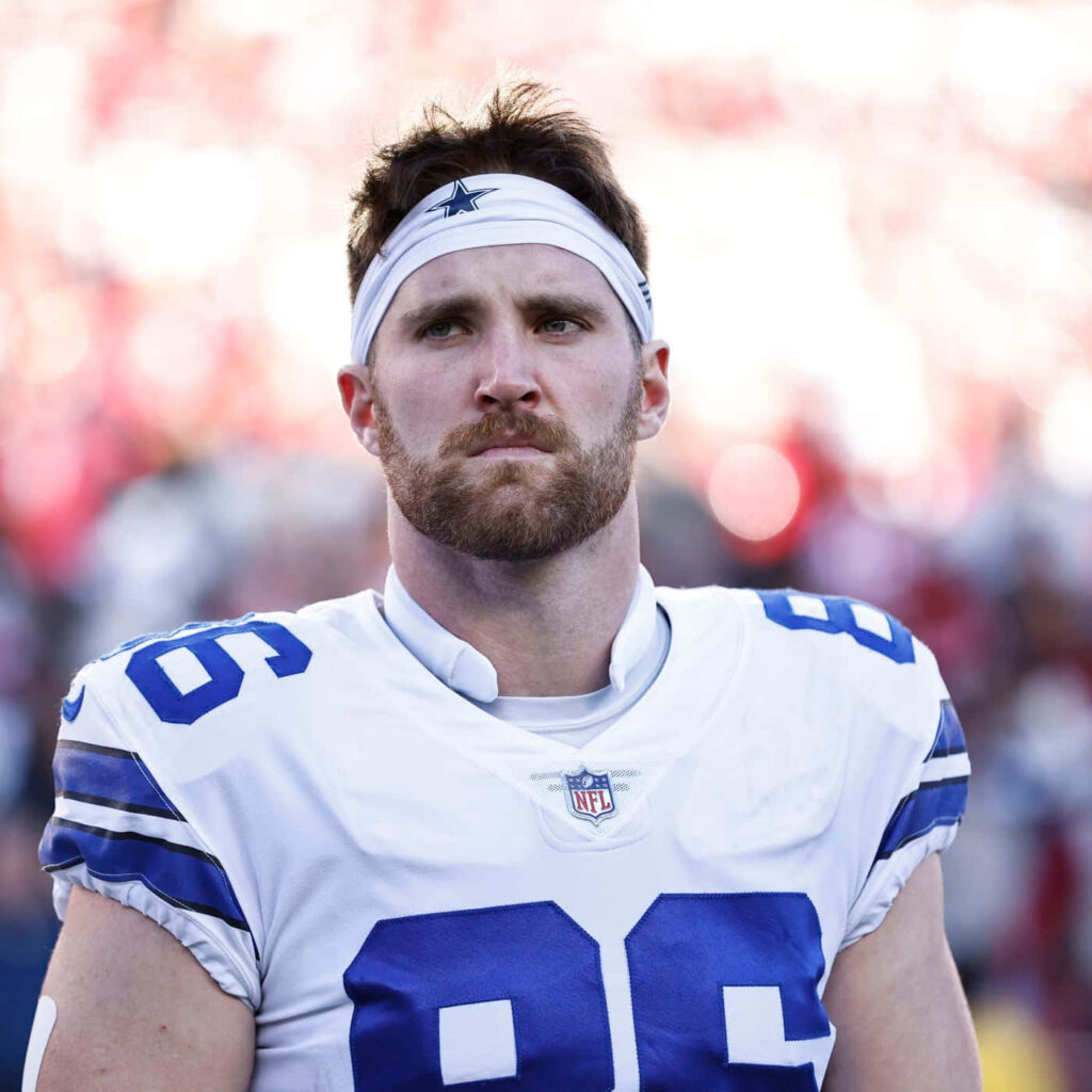 Dalton Schultz Dallas Cowboys focused portrait football player blue white uniform stadium background Wallpaper
