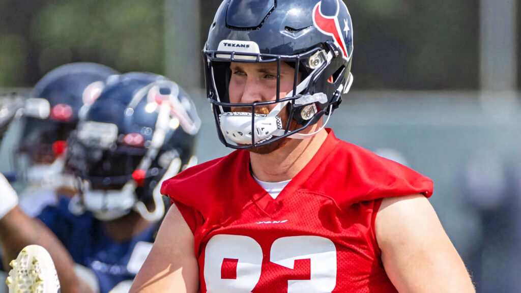 Dalton Schultz in red Houston Texans jersey during intense football training session wallpaper