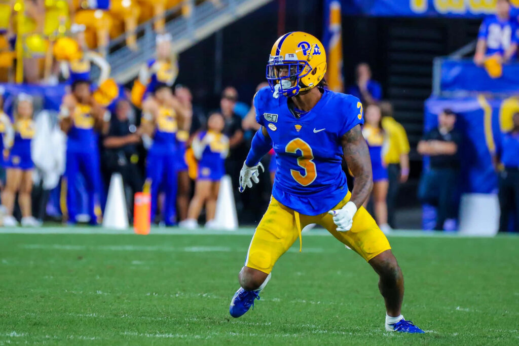 Damar Hamlin in blue and gold Pitt Panthers uniform in defensive stance on football field wallpaper