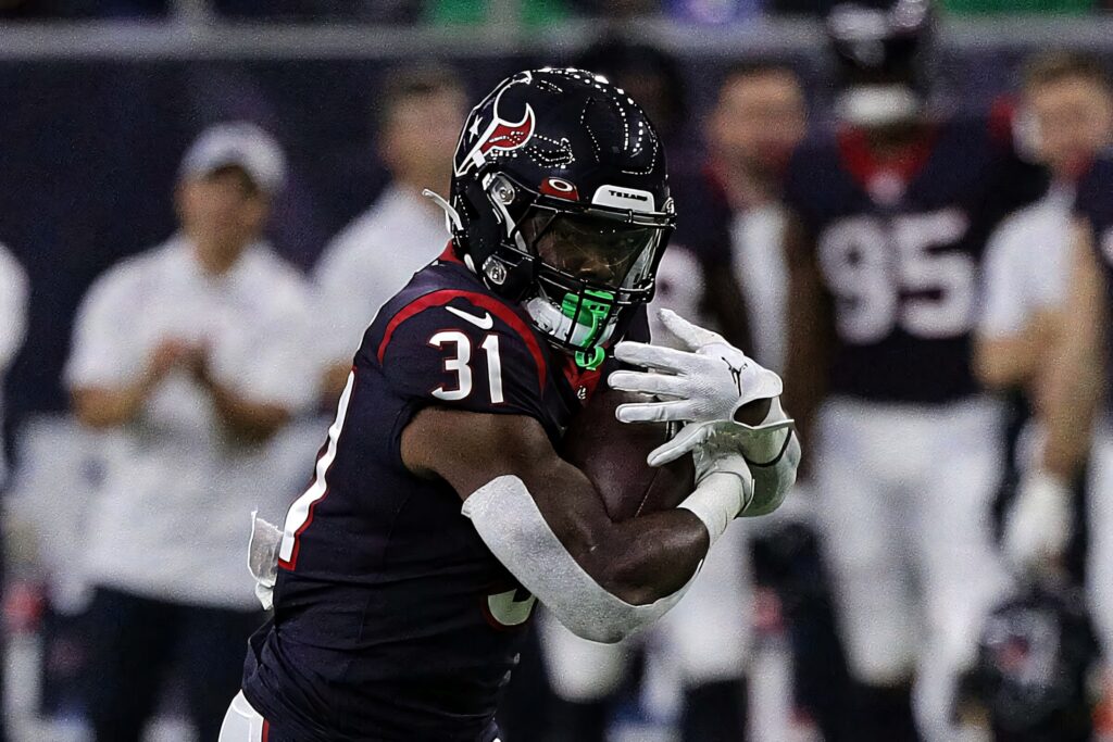 Dameon Pierce Houston Texans running strong in black uniform high energy football action wallpaper