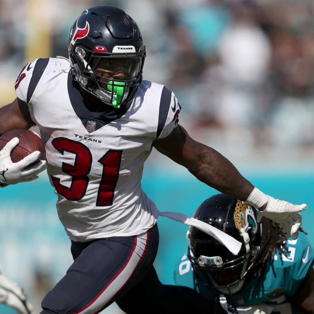 Dameon Pierce Houston Texans running back charges past Jacksonville Jaguars defender in action Wallpaper
