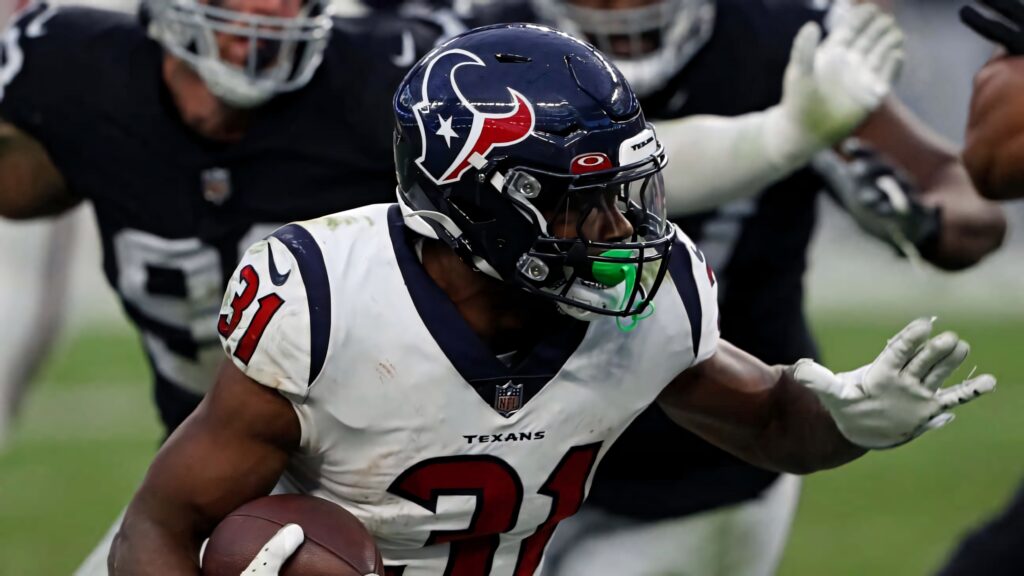 Dameon Pierce Houston Texans running back charging defenders NFL action dynamic wallpaper