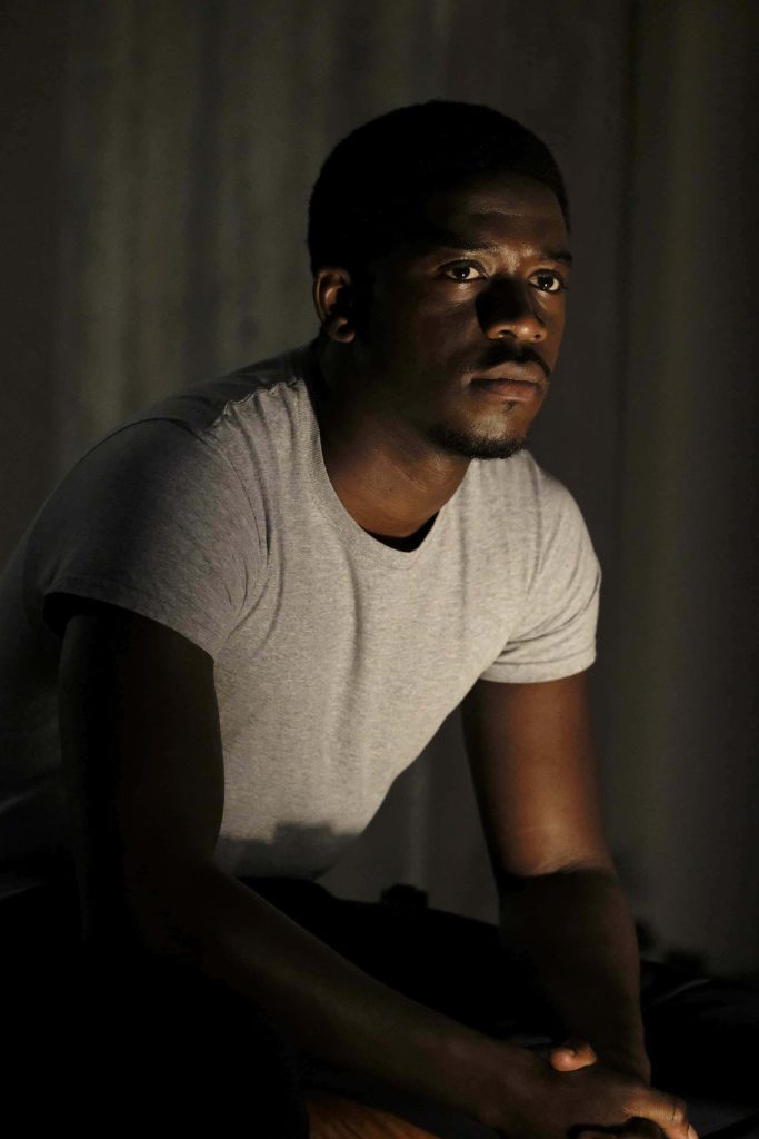 Damson Idris as Franklin Saint in Snowfall high contrast portrait with moody dark background wallpaper