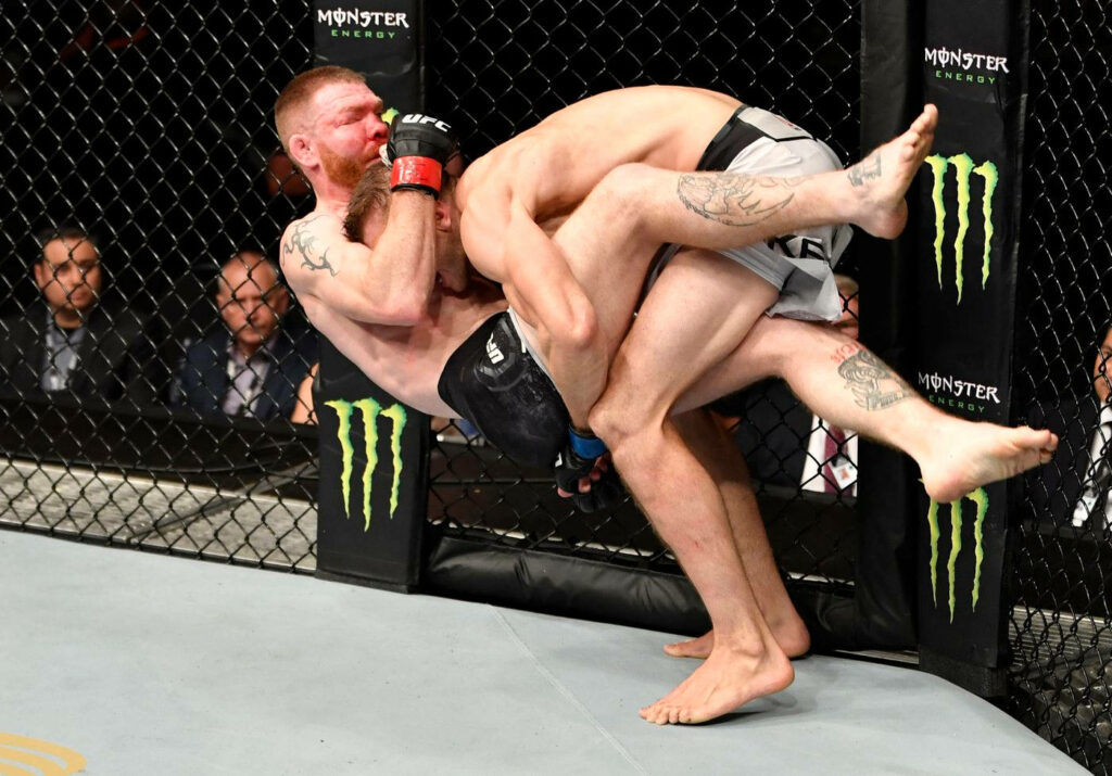 Dynamic UFC Wallpaper: Dan Hooker Lifts Opponent in Intense Moment