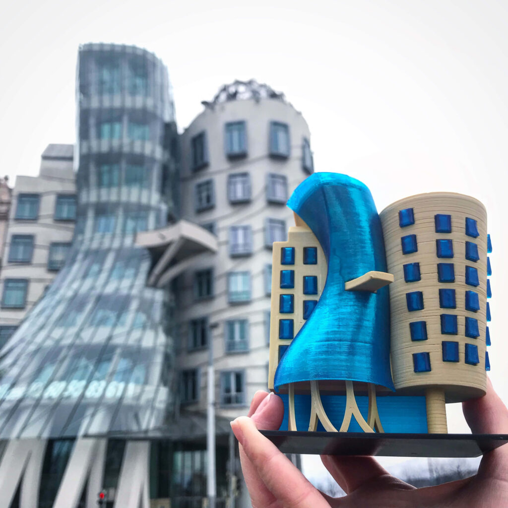 Dancing House Prague wallpaper with modern glass curves blue beige tones and creative mini model