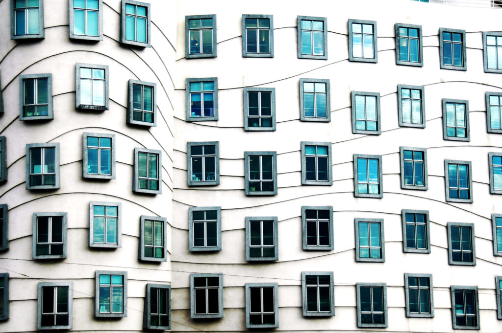 Dancing House Prague wallpaper showing iconic curving lines and blue framed windows facade
