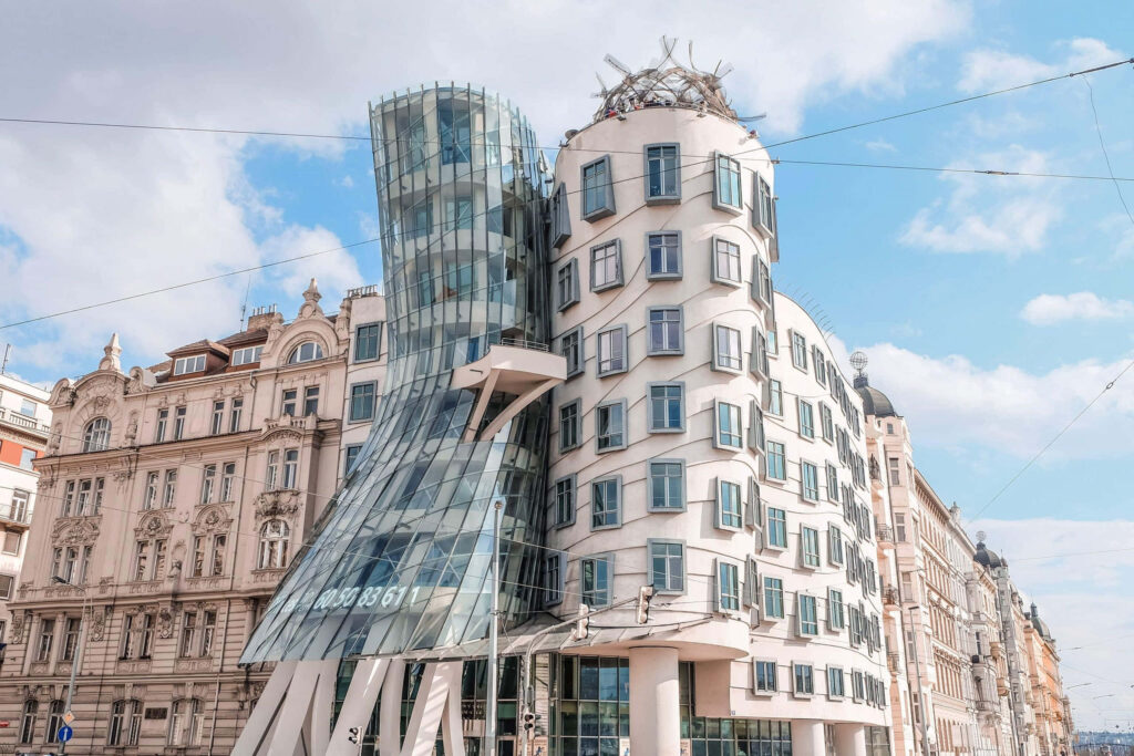 Dancing House Prague modern twisting glass concrete building bright blue sky urban scene wallpaper