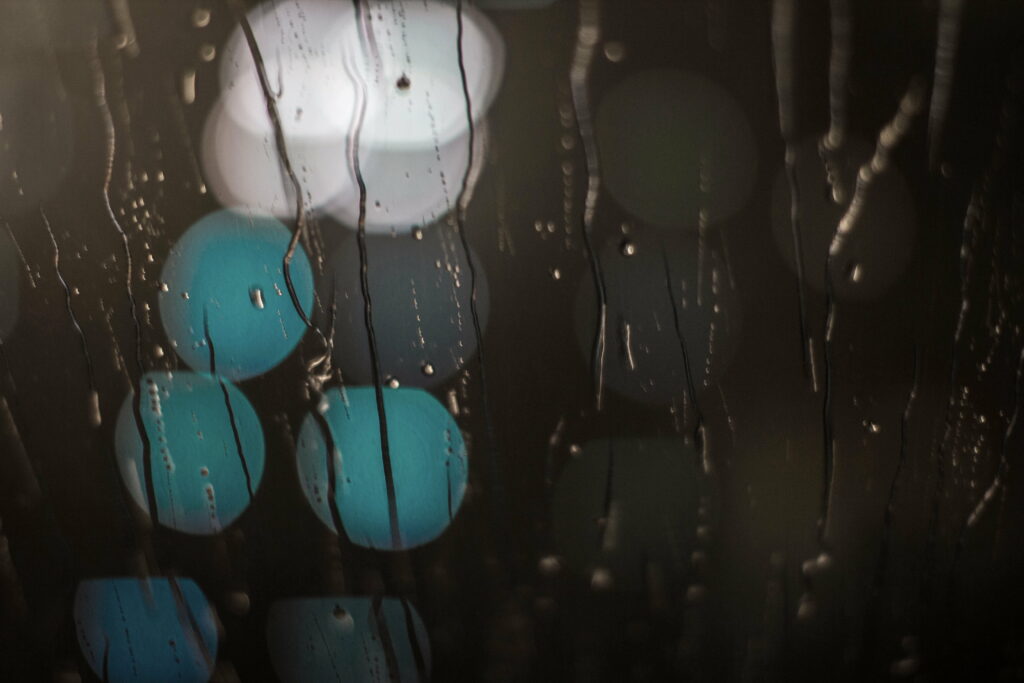Rain's Dance: Captivating Macro Perspective with Long Exposure on Glass Lights Wallpaper