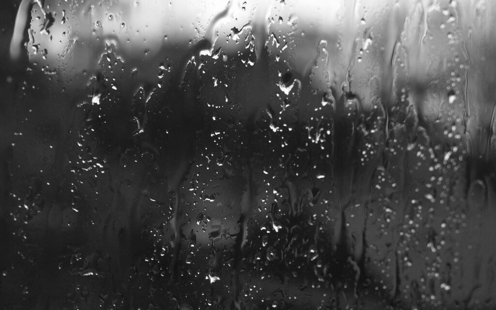 Black and white macro wallpaper with realistic raindrops on glass for a serene minimalist background