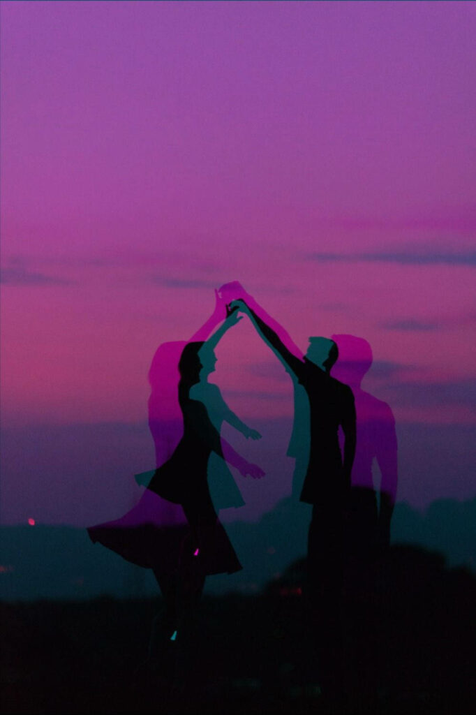 Vibrant Purple iPhone Background: Dancing Couple Embraced by Stunning Violet Sky Wallpaper