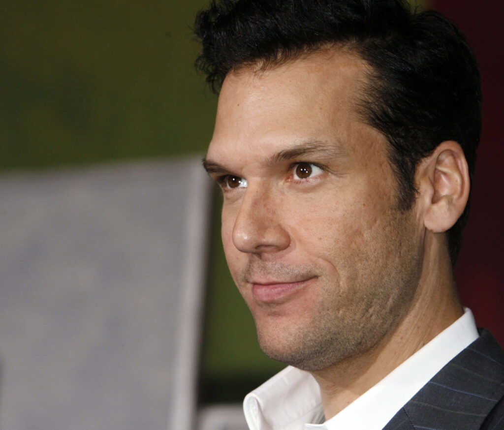 Close-up portrait of Dane Cook in formal suit with blurred green neutral background wallpaper