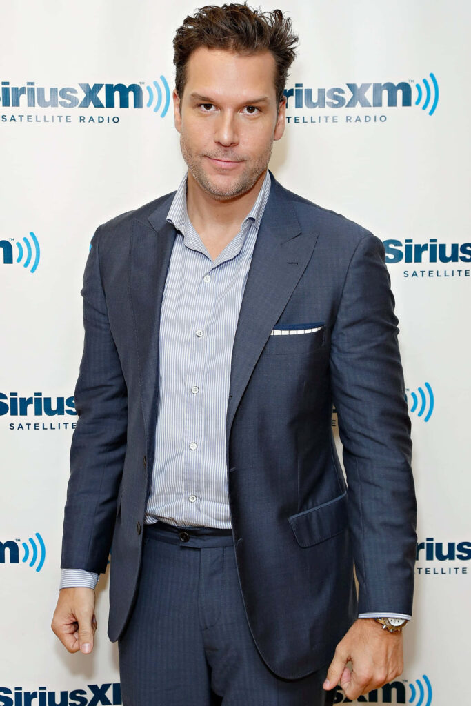 Dane Cook in sharp blue suit at SiriusXM studio with natural lighting professional wallpaper background