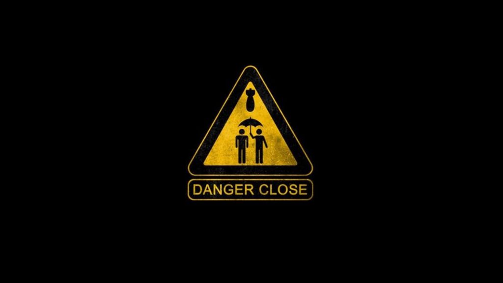 Danger Close warning sign wallpaper black background yellow triangle figures umbrella falling bomb