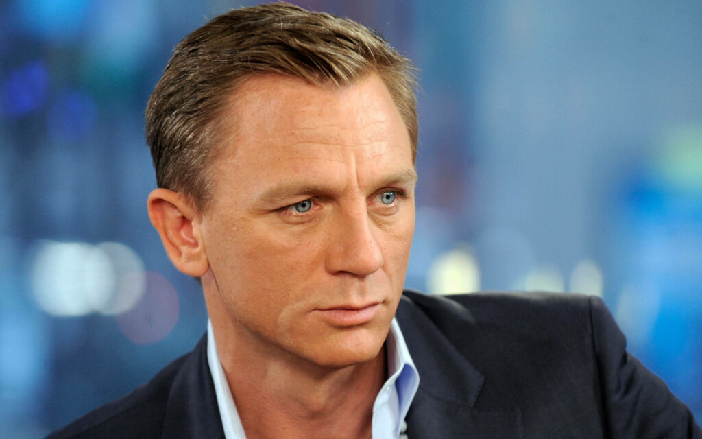 Close-up portrait of Daniel Craig with intense gaze sharp features celebrity wallpaper background