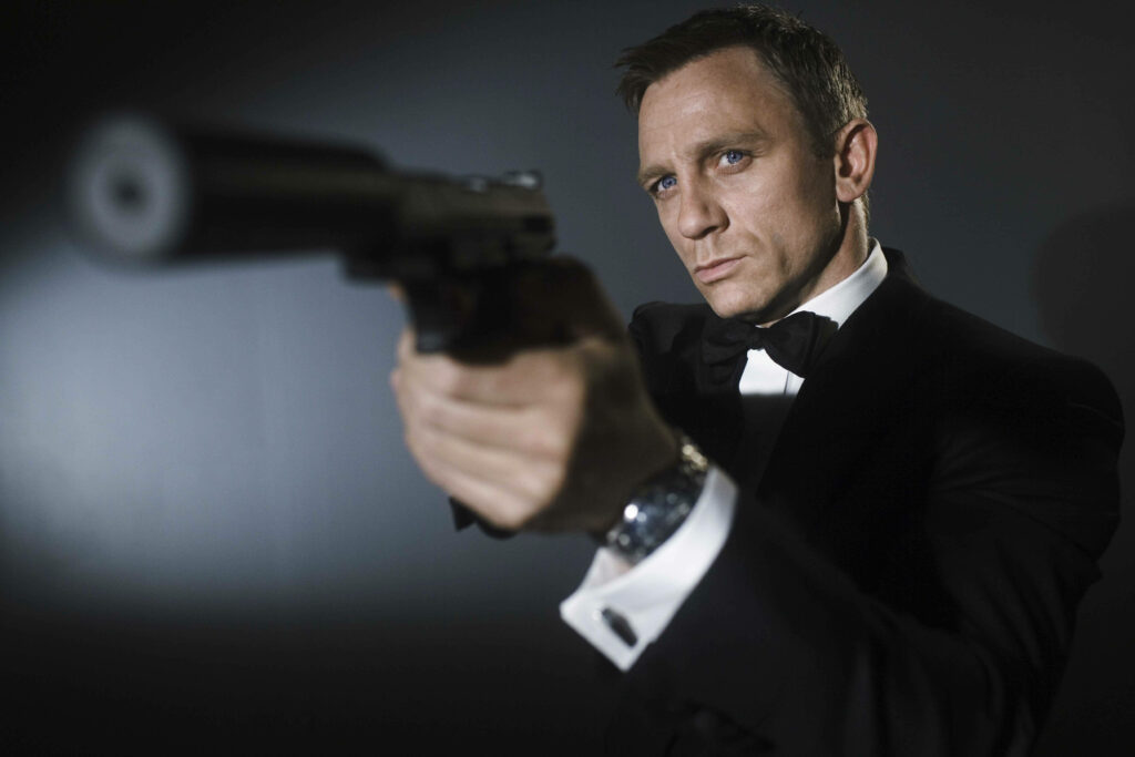 Daniel Craig in classic tuxedo aiming silenced pistol iconic British secret agent wallpaper