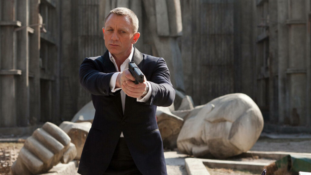 Daniel Craig as James Bond in sharp suit holding gun intense Skyfall movie scene wallpaper