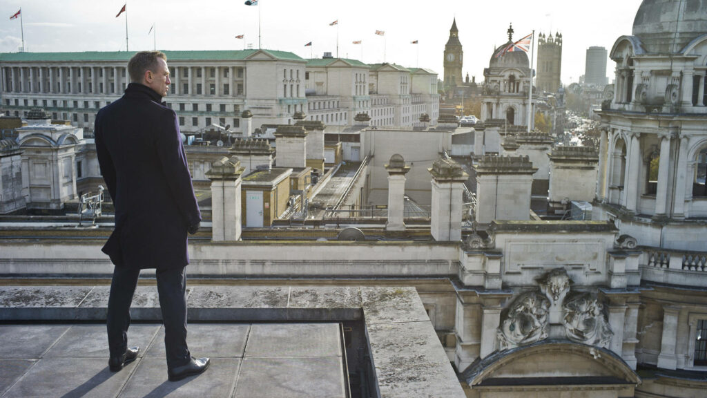 Daniel Craig as James Bond on London rooftop with cityscape background confident spy wallpaper
