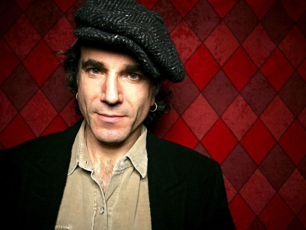 Daniel Day-Lewis portrait with textured cap dark jacket moody lighting red diamond wall background Wallpaper