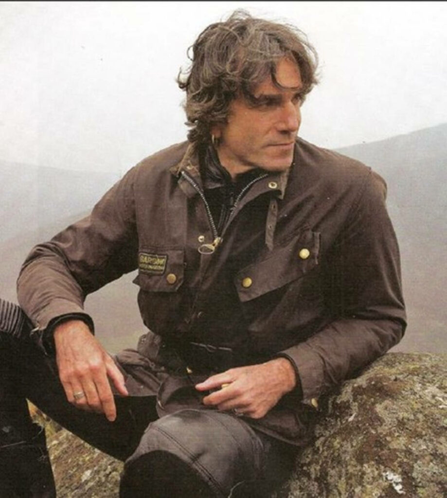 Daniel Day-Lewis in brown jacket with gold accents in misty rugged landscape outdoors wallpaper