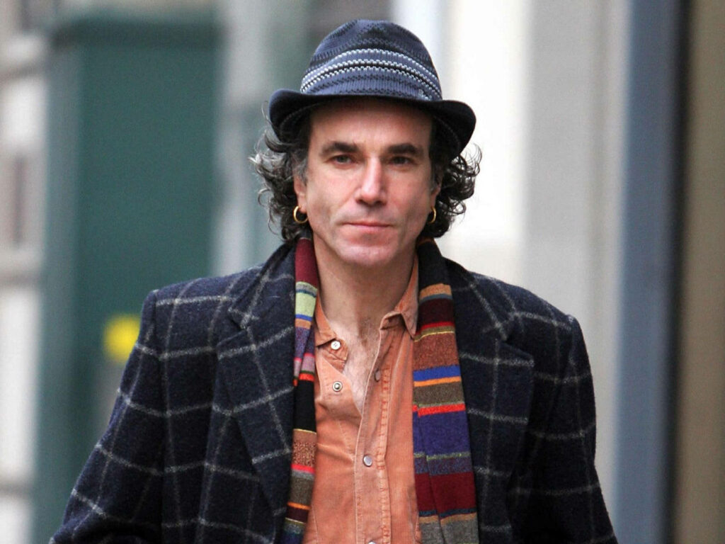 Daniel Day-Lewis walking city street wearing patterned hat checkered coat colorful striped scarf Wallpaper