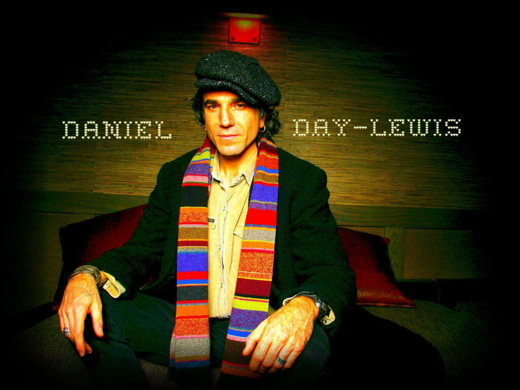 Daniel Day-Lewis smiling warmly with colorful scarf and cap against warm toned background Wallpaper