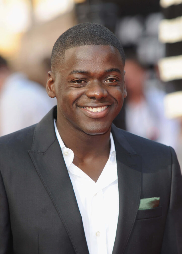 Daniel Kaluuya in black suit white shirt smiling confidently high resolution wallpaper background
