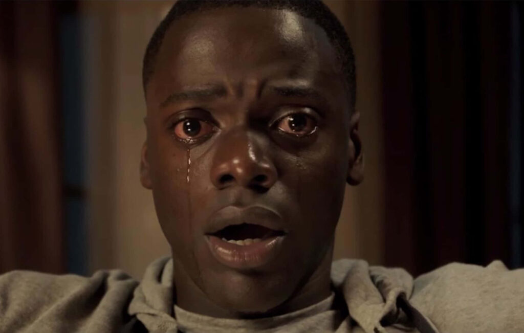 Daniel Kaluuya close up with tear and fearful eyes in dimly lit dramatic suspenseful scene wallpaper