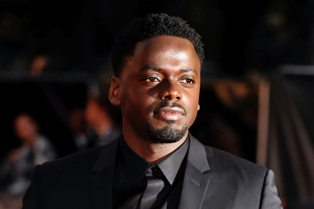 Daniel Kaluuya in sharp black suit with confident expression soft blurred natural light background Wallpaper