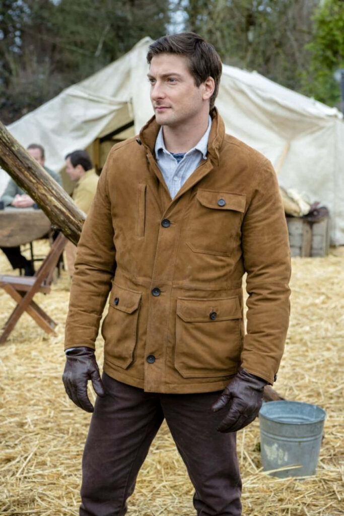 Daniel Lissing outdoors by canvas tent in brown suede jacket rugged rustic countryside style Wallpaper