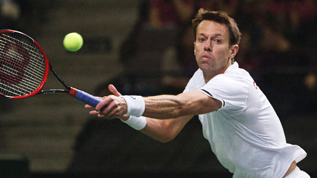 Daniel Nestor lunging on tennis court reaching fast ball dynamic action shot athletic focused Wallpaper