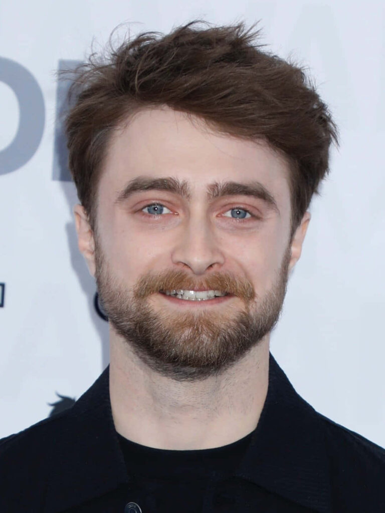 Daniel Radcliffe portrait wallpaper with beard blue eyes tousled hair neutral background sharp detail