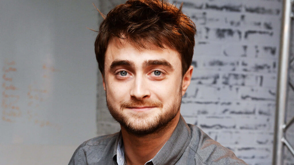 Daniel Radcliffe casual portrait warm lighting tousled hair textured modern wallpaper background