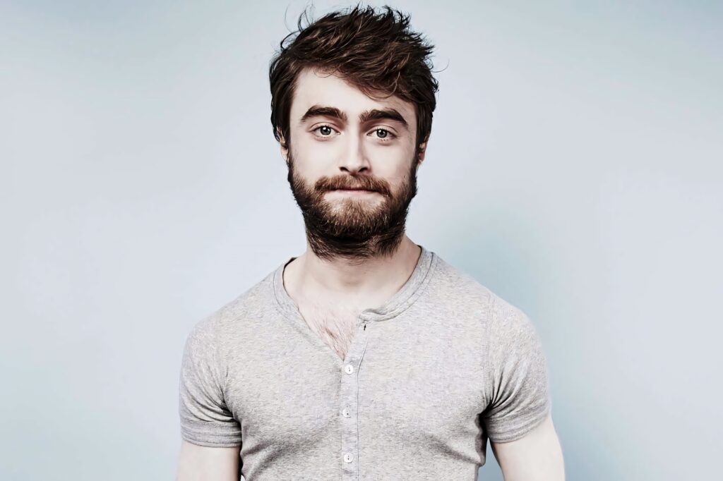 Daniel Radcliffe portrait in light grey henley shirt with natural lighting and soft gradient background Wallpaper