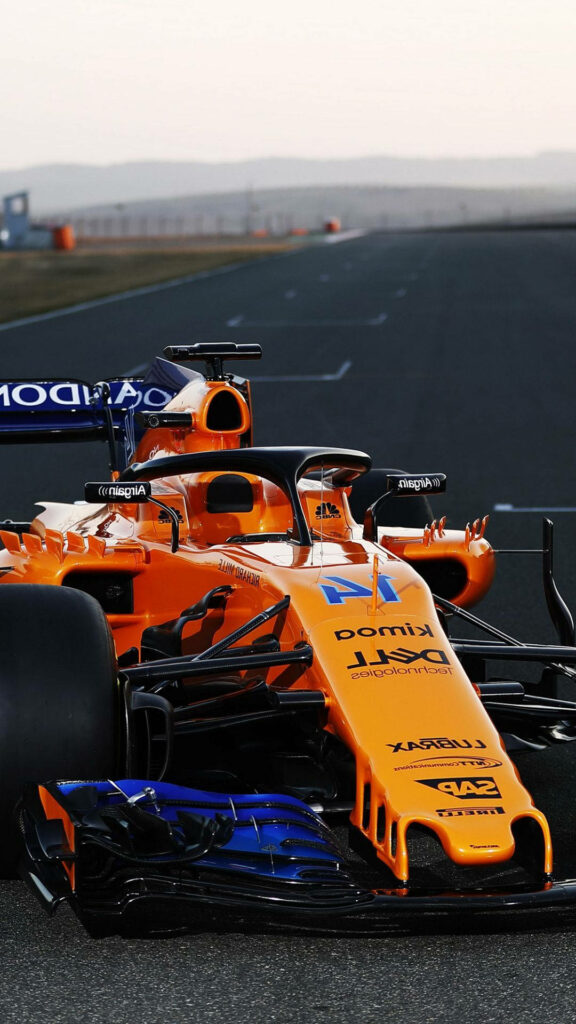 Daniel Ricciardo Formula 1 car in vibrant orange livery speeding on track wallpaper background