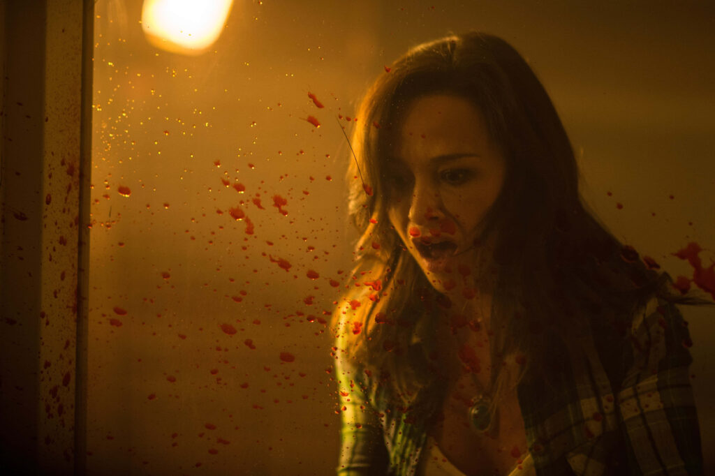 Danielle Harris intense horror scene shocked expression dramatic lighting blood splattered glass Wallpaper
