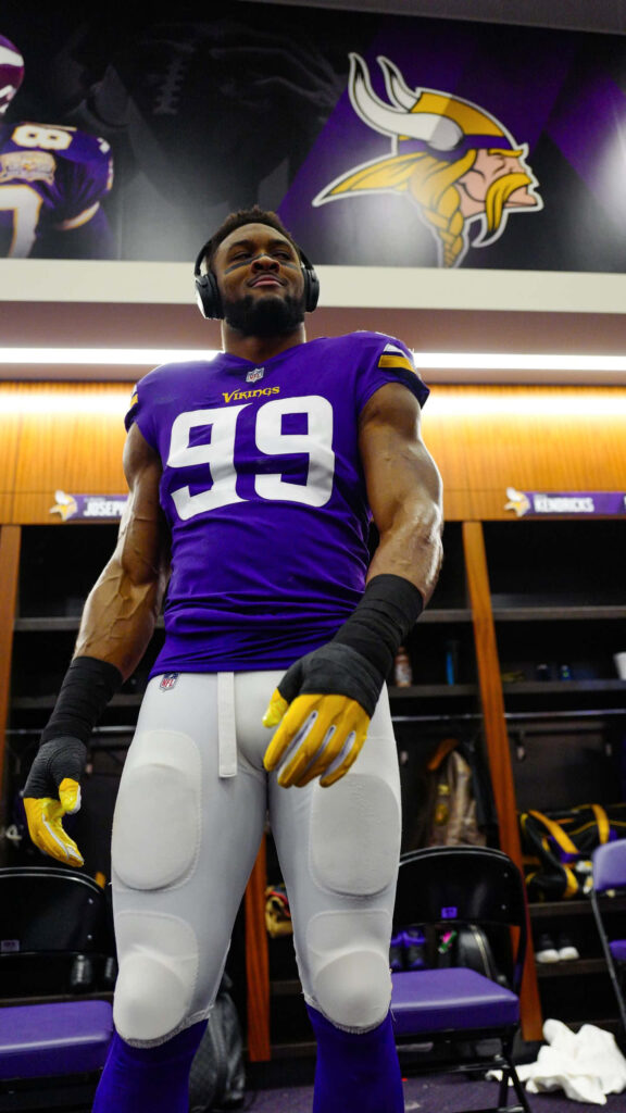 Danielle Hunter Minnesota Vikings in locker room focused with headphones wearing purple white uniform Wallpaper