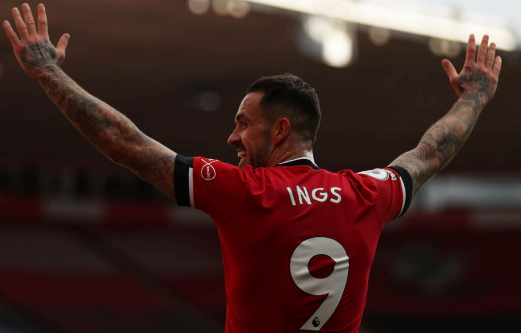 Danny Ings celebrating with arms raised wearing number 9 jersey in stadium with dramatic lighting Wallpaper
