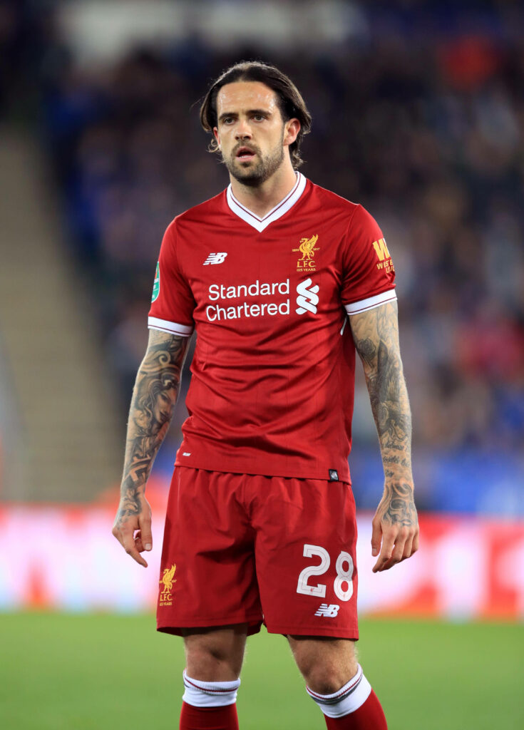 Danny Ings in red Liverpool FC kit on football field showing focused expression and tattoos Wallpaper