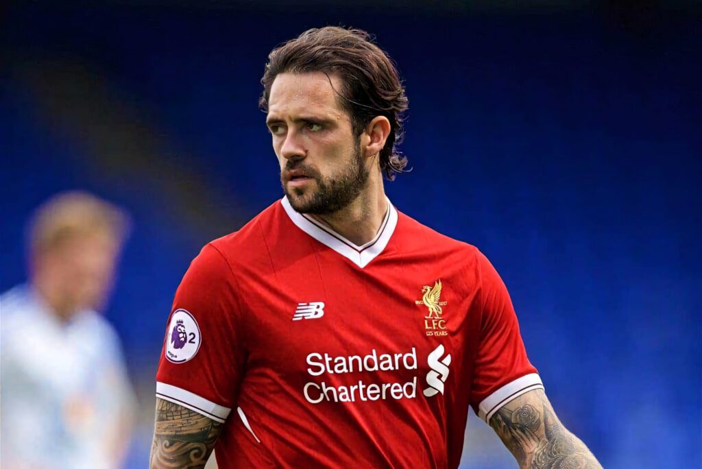 Danny Ings in Liverpool FC home kit intense pose focused sharp details football background Wallpaper