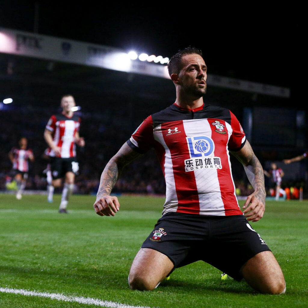 Danny Ings celebrating on knees in Southampton red white black kit under stadium lights wallpaper