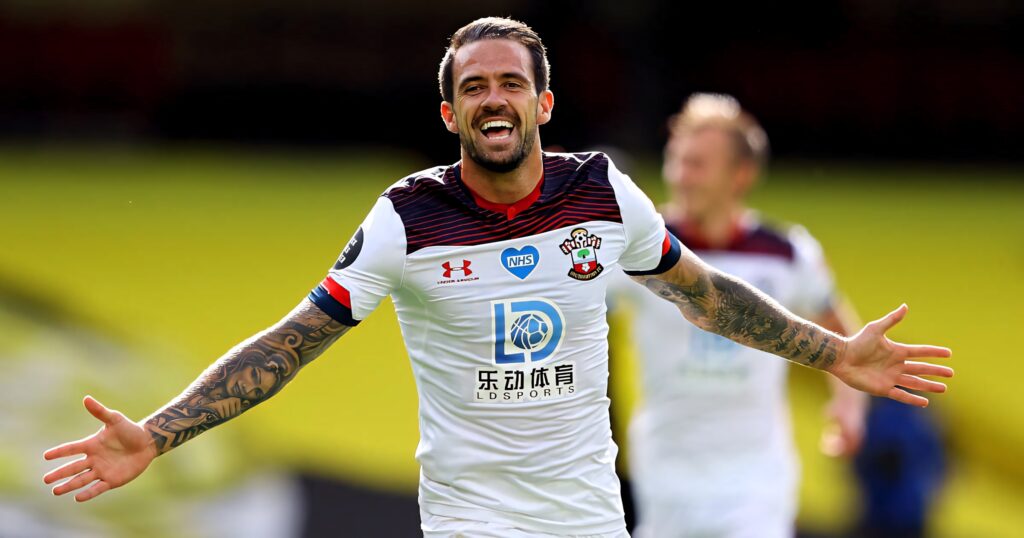 Danny Ings celebrating a goal in Southampton FC kit with arms outstretched and smiling widely Wallpaper